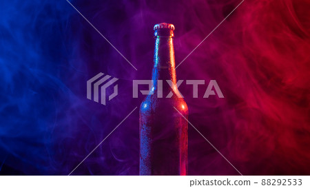 Glass bottle of beer in blue pink mist 88292533