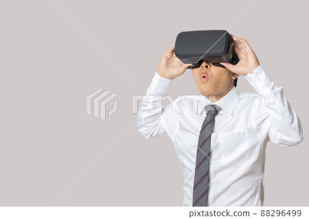 Studio portrait man wearing VR Headset isolated on gray background Studio portrait man wearing VR Headset isolated on gray background 88296499