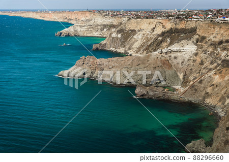 View of Crimean rugged rocky with Diana's Grotto and beach from top of the cliff on Fiolent Cape. Sevastopol. Crimea 88296660