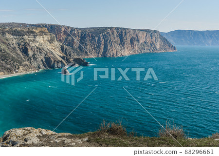 View of Crimean rugged rocky shore with Saint George Monastery and rock of Holy Apparition from Cape Fiolent in spring. Sevastopol, Crimea 88296661