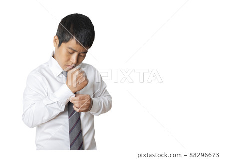Portrait of businessman wearing white shirt adjusting his cuff links. Portrait of businessman wearing white shirt adjusting his cuff links. 88296673