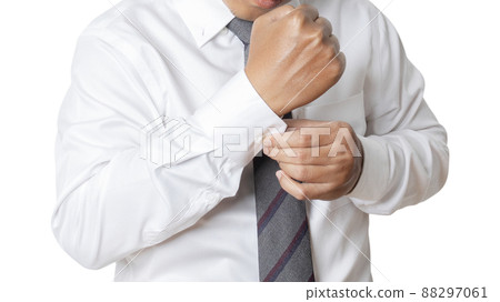 Portrait of businessman wearing white shirt adjusting his cuff links. Portrait of businessman wearing white shirt adjusting his cuff links. 88297061