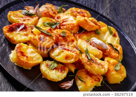roasted squashed potatoes with garlic and sage 88297519