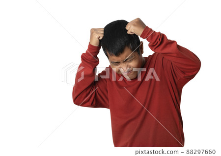Portrait of young asian man showing headache gesture and ill. 88297660