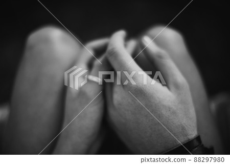 Finding love in dark places. Top view black and white image of two lovers holding hands. Finding love in dark places. Top view black and white image of two lovers holding hands. 88297980