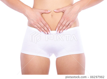 Nothing to worry about. Cropped studio shot of a woman measuring her waistline isolated on white. Nothing to worry about. Cropped studio shot of a woman measuring her waistline isolated on white. 88297982
