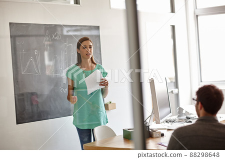 Smart advice from innovative businesspeople. Shot of a young designer presenting her business strategy. 88298648