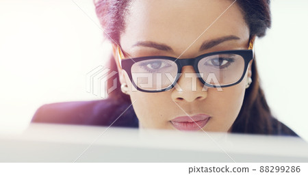 Shes a very focused individual. Cropped shot of an attractive young businesswoman working on her computer in the office. 88299286