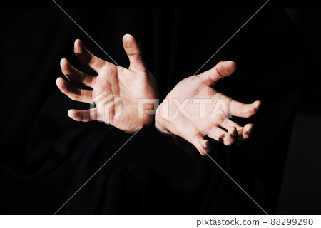 Theyre coming to grab you. Two hands isolated against a black background. Theyre coming to grab you. Two hands isolated against a black background. 88299290
