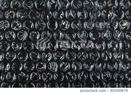The texture of the packaging air-bubble film on a Black background in full screen The texture of the packaging air-bubble film on a Black background in full screen 88300674