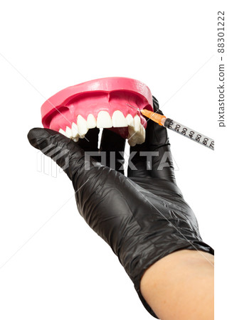 Dentist with layout of the human jaw and syringe. Dentist with layout of the human jaw and syringe. 88301222