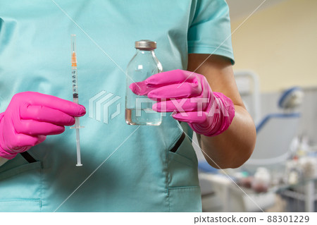 Plastic syringe and bottle for liquid medicine in doctor's hands. Plastic syringe and bottle for liquid medicine in doctor's hands. 88301229