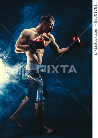 Full size of sportsman muscular boxer who fighting on black smoke background. Boxing sport concept 88301761