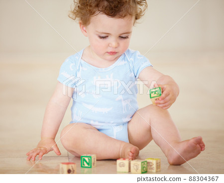 Building blocks to a bright future. Full length shot of a cute baby boy playing with toy blocks. 88304367