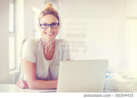 Career confidence. Portrait of a happy woman working at her desk in a casual office environment. 88304435