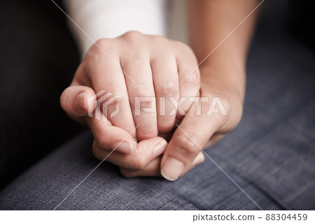 Be a rainbow in someone elses cloud. Cropped shot of two people holding hands in comfort. 88304459