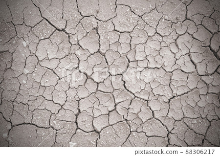 Full frame to terrain with arid climate. The surface of the land is cracked. crack soil ground texture. The natural texture of soil with cracks. Broken clay surface of barren dryland wasteland closeup 88306217