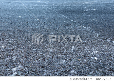 Road surface that became an ice burn after the snow melted 88307802