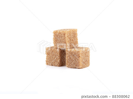Three cubes of cane sugar on a white background. Three cubes of cane sugar on a white background. 88308062