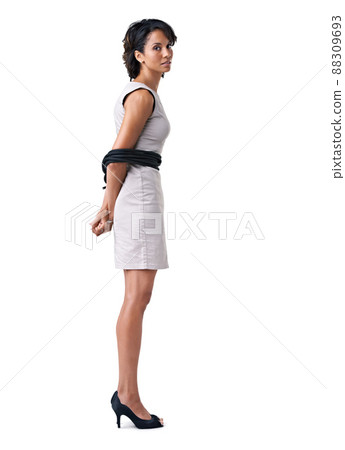 Struggling against corporate restrictions. Studio portrait of a businesswoman tied up with ropes against a white background. Struggling against corporate restrictions. Studio portrait of a businesswoman tied up with ropes against a white background. 88309693