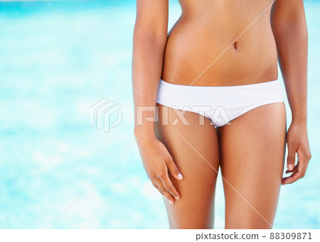In great shape. Cropped view of a curvy young woman in a white bikini. 88309871