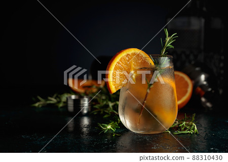 Cocktail gin tonic with ice, orange, and rosemary. Cocktail gin tonic with ice, orange, and rosemary. 88310430