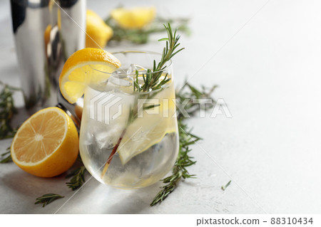 Refreshing drink with natural ice, lemon, and rosemary. 88310434