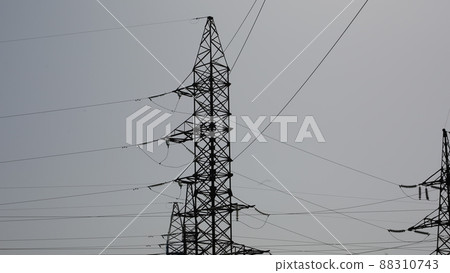 Power station. Transmission towers to provide energy to a residential area. Steel structures for generating electricity Power station. Transmission towers to provide energy to a residential area. Steel structures for generating electricity 88310743