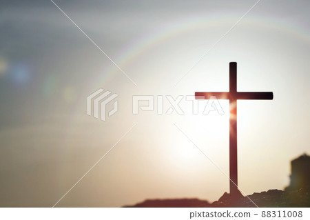 The cross of Jesus Christ shining in the rainbow sky and clouds sunlight The cross of Jesus Christ shining in the rainbow sky and clouds sunlight 88311008