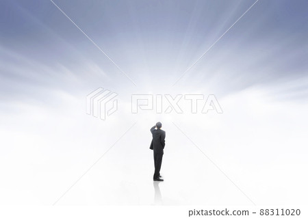 A business man who dreams of leaps and bounds, growth and success by designing and forecasting a bright future with shining sky and clouds A business man who dreams of leaps and bounds, growth and success by designing and forecasting a bright future with shining sky and clouds 88311020
