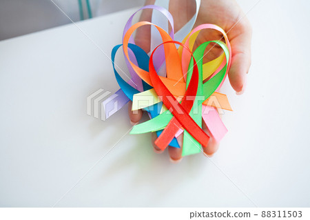 Female doctor holds colored ribbons symbolize awareness of various diseases 88311503