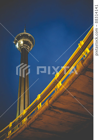 Night View of Macau Tower in Twilight Time Macau Tower Convention and Entertainment Centre. The landmark of the city. Sightseeing attractions. The tenth tallest sightseeing tower in the world. Night View of Macau Tower in Twilight Time Macau Tower Convention and Entertainment Centre. The landmark of the city. Sightseeing attractions. The tenth tallest sightseeing tower in the world. 88314141