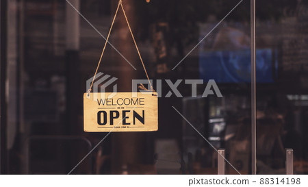 Wooden sign board hanging on door of cafe restaurant .Open vintage sign broad through the glass of store window.commercial business background for advertisement Wooden sign board hanging on door of cafe restaurant .Open vintage sign broad through the glass of store window.commercial business background for advertisement 88314198