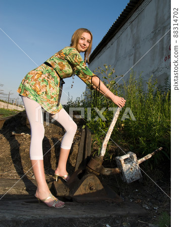 Pretty girl throws railway switch Pretty girl throws railway switch 88314702