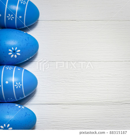 Blue Easter eggs on white wooden background 88315187