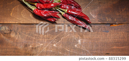 Red hot chili peppers on a wooden background Red hot chili peppers on a wooden background 88315299
