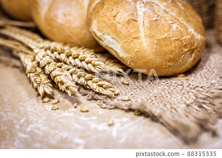 Fresh bread and wheat on a rustic background 88315335