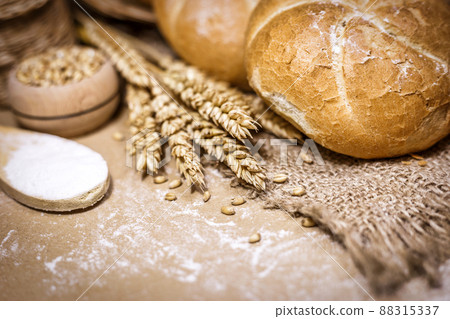 Freshly baked bread, wheat and flour on a rustic background 88315337