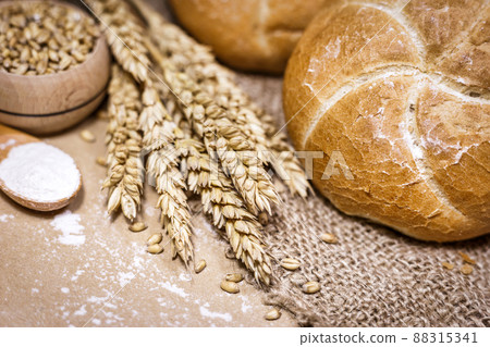 Freshly baked bread, wheat and flour on a rustic background 88315341