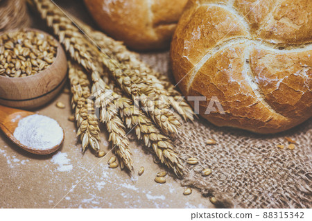 Freshly baked bread, wheat and flour on a rustic background 88315342