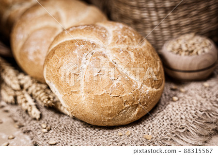 Fresh bread and wheat on a rustic background 88315567