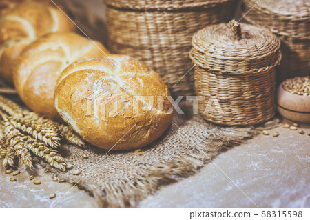 Fresh bread and wheat on a rustic background Fresh bread and wheat on a rustic background 88315598
