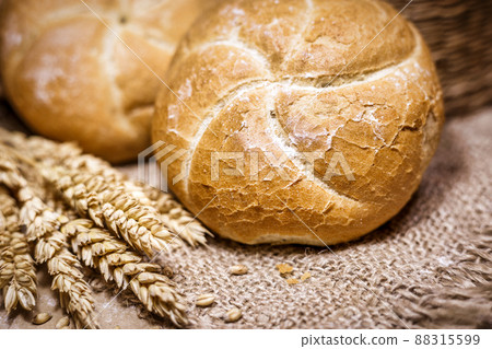 Fresh bread and wheat on a rustic background 88315599