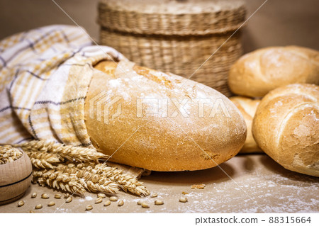 Fresh bread and wheat on a rustic background Fresh bread and wheat on a rustic background 88315664