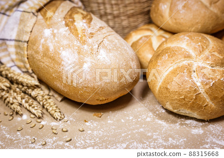 Fresh bread and wheat on a rustic background 88315668