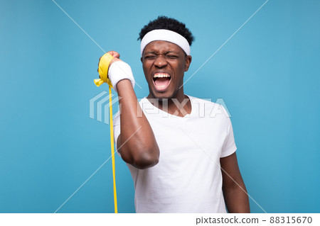 Funny african american sportsman doing sport exercise. 88315670