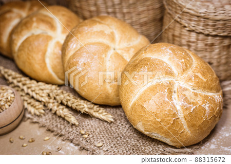Fresh bread and wheat on a rustic background 88315672