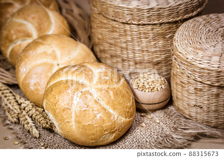 Fresh bread and wheat on a rustic background 88315673