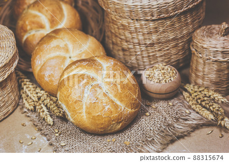 Fresh bread and wheat on a rustic background 88315674