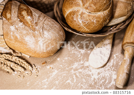 Freshly baked bread, wheat and flour on a rustic background 88315716